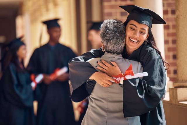 A graduate hugging her parent.
