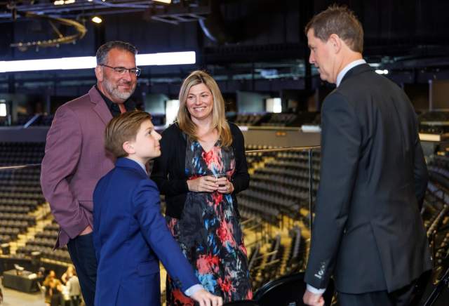 A group smiling in the arena.