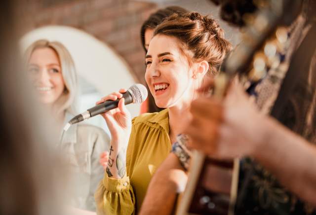 A girl singing into a microphone.