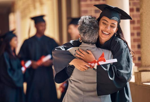 A graduate hugging her parent.