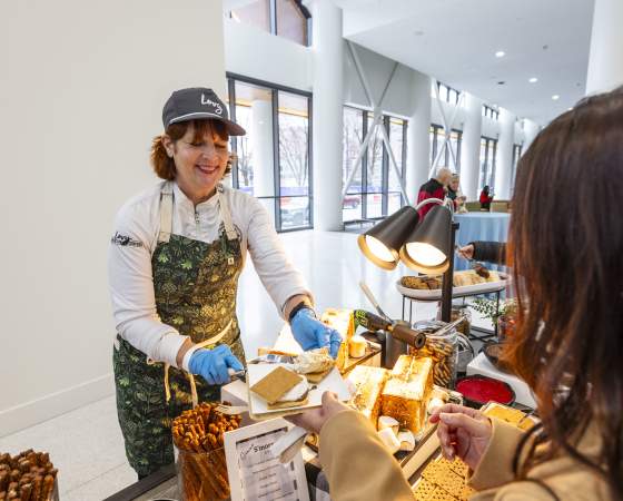 A chef prepares a toasted s’more for a guest at an interactive dessert station inside First Financial Center.