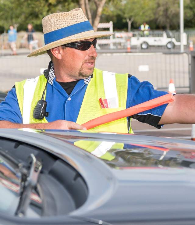 a parking assistant directing traffic for an event at the Buddy Holly Hall in Lubbock