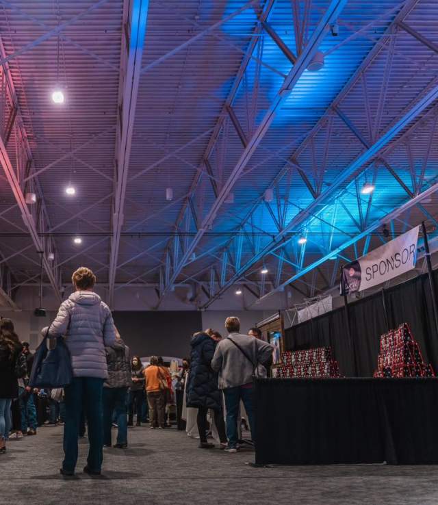 Attendees walking to vendor booths during a bridal expo