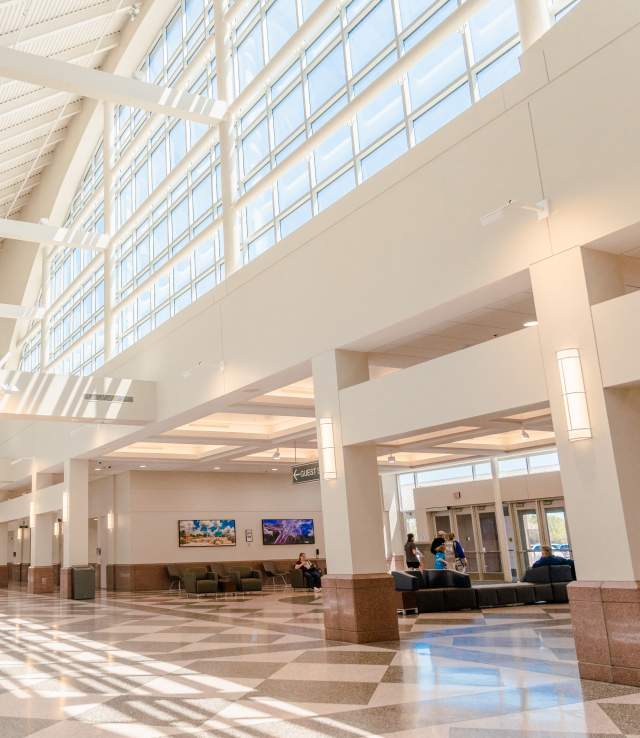 empty concourse hallway with large windows and natural lighting
