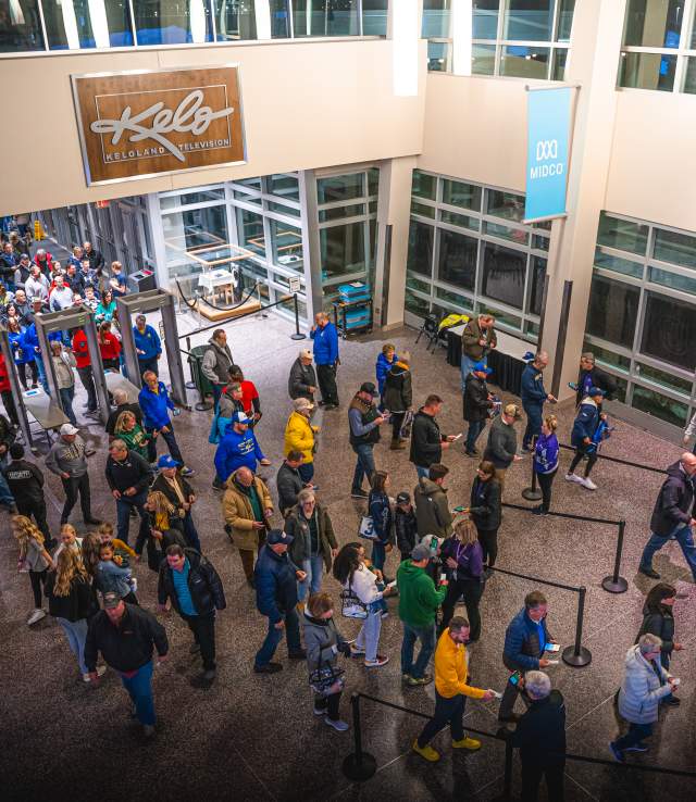 Fans entering in through security checkpoints during an event and then getting their tickets scanned