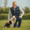 Adam Henson with a sheepdog at Cotswold Farm Park
