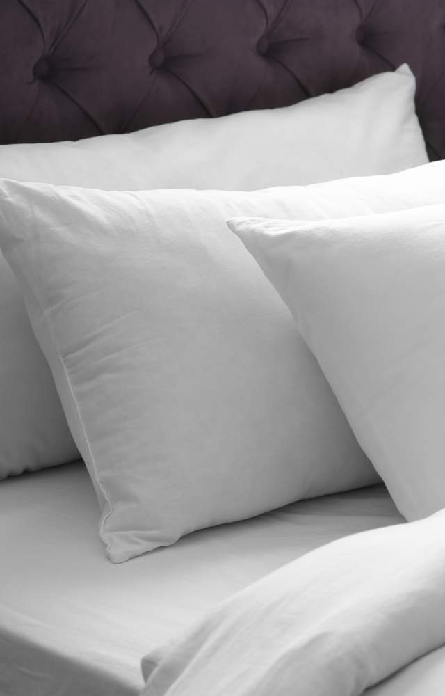 Hotel bed with white linens