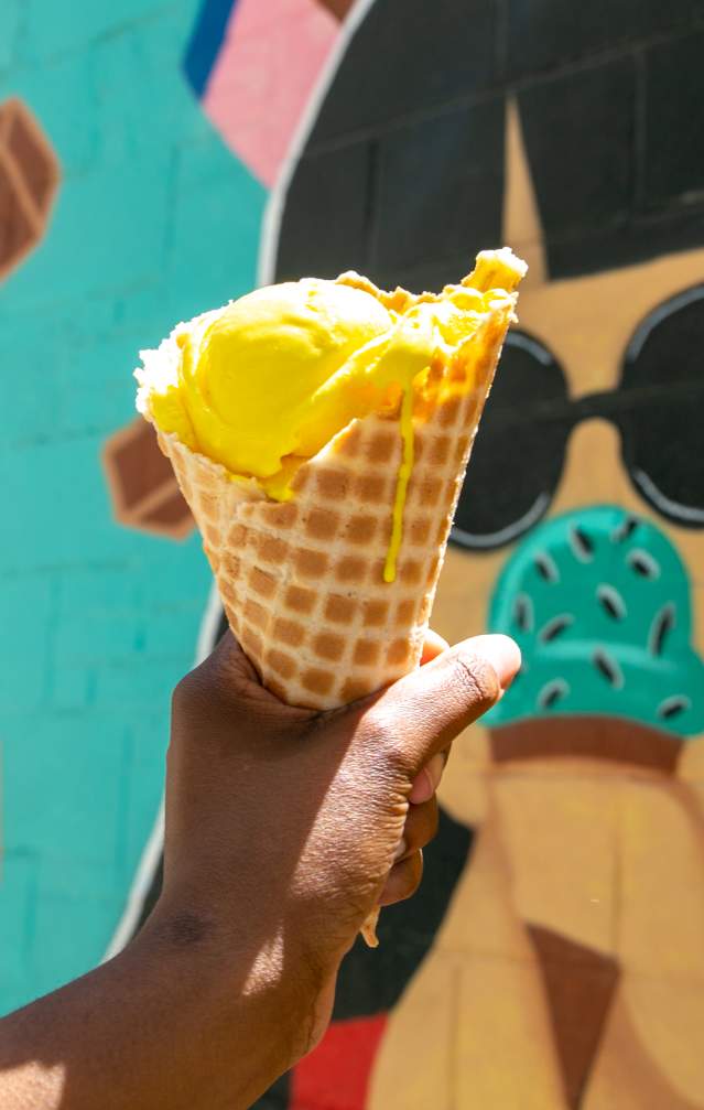Chocolate Moose ice cream cone held in front of their mural