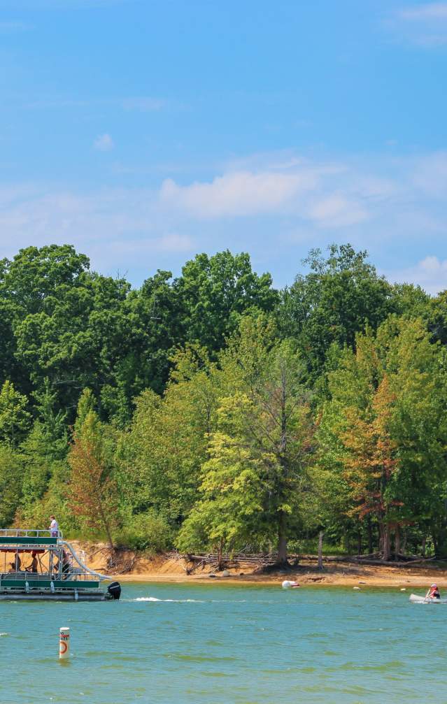 A pontoon and two kayaks on Monroe Lake at the Paynetown SRA