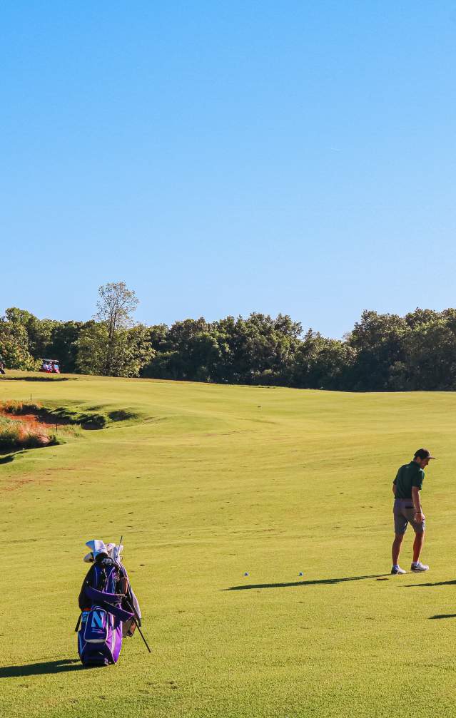 Three men playing golf at The Pfau Course at Indiana University