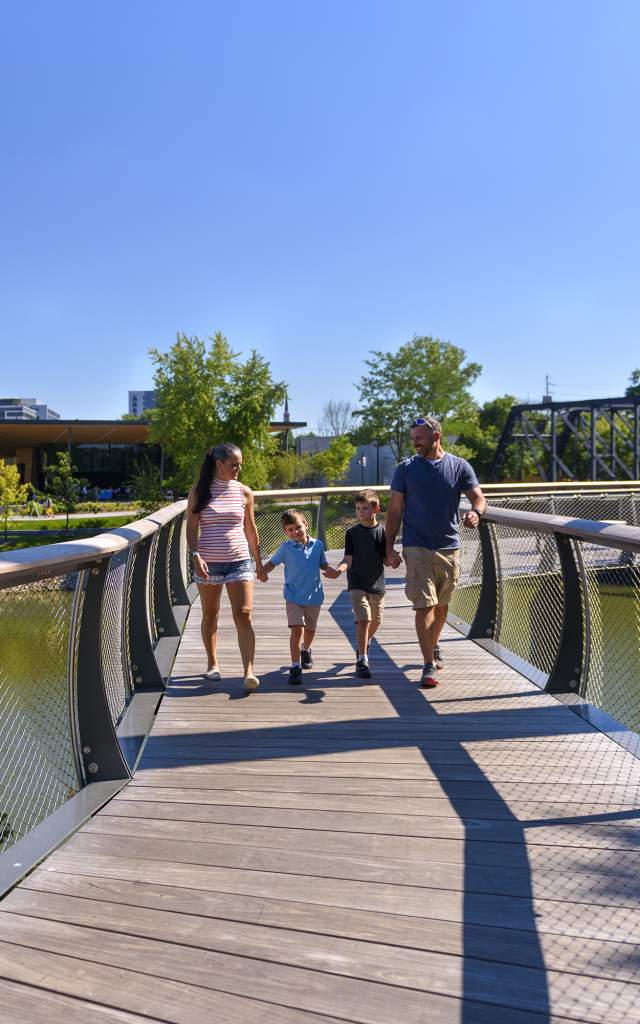 Family walking on the Tree Canopy Trail at Promenade Park