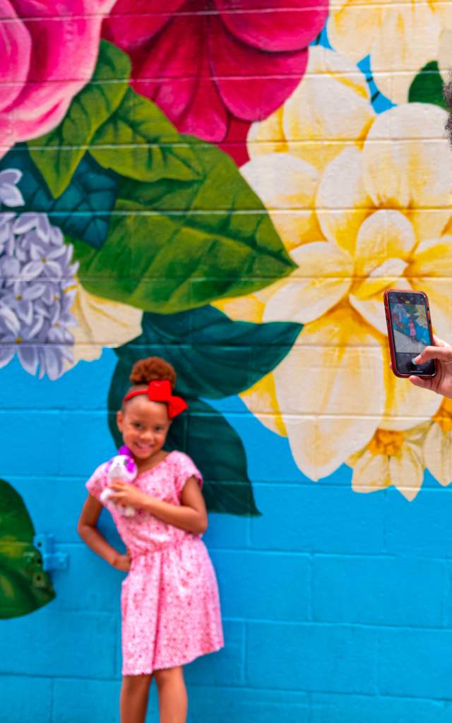 Family posing at Walt Whitman Mural downtown