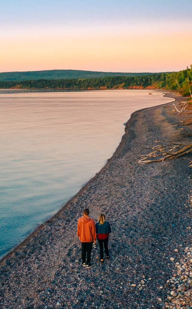 Aerial shot of a couple walking along a Lake Superior beach in Ironwood, located in the Upper Peninsula of Michigan