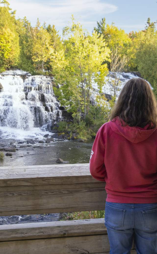A couple looking out at Bond Falls, located in the Upper Peninsula of Michigan