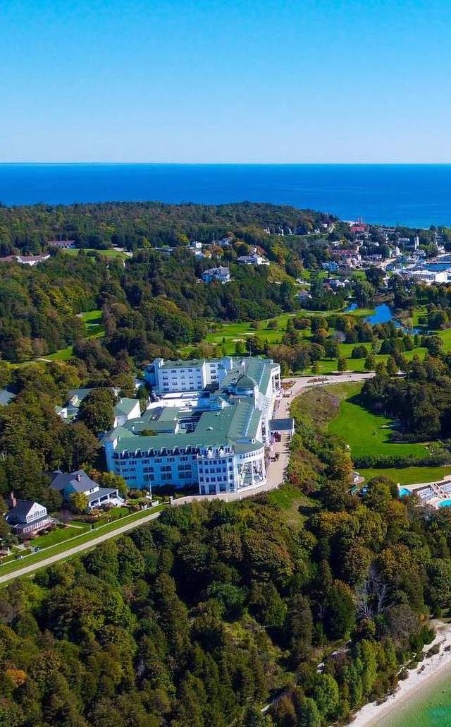 an aerial shot of mackinac island, the grand hotel and surrounding area
