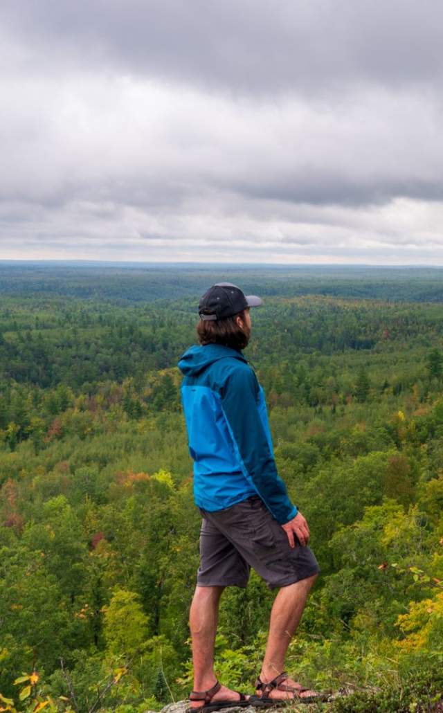 A man overlooking the Ottawa National Forest, located in the Upper Peninsula of Michigan