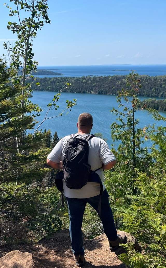 Hiker overlooking Lake Superior on a hiking trail at Isle Royale National Park in the Upper Peninsula of Michigan