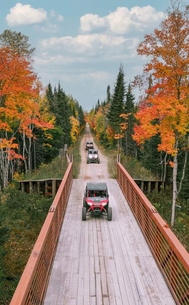UTV's crossing a bridge during fall color in the Upper Peninsula of Michigan