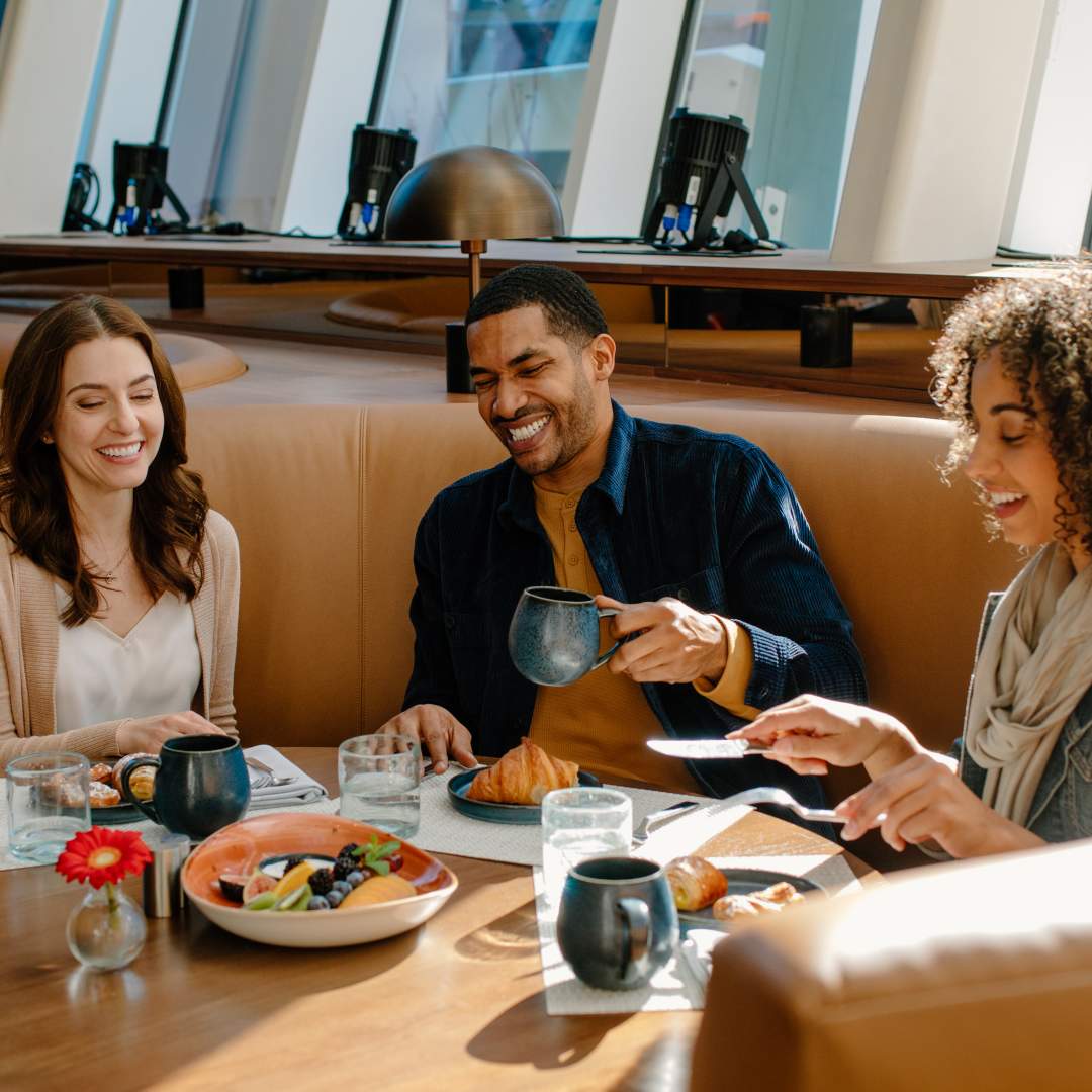 Three people eating breakfast at FYR in the Hilton Columbus Downtown