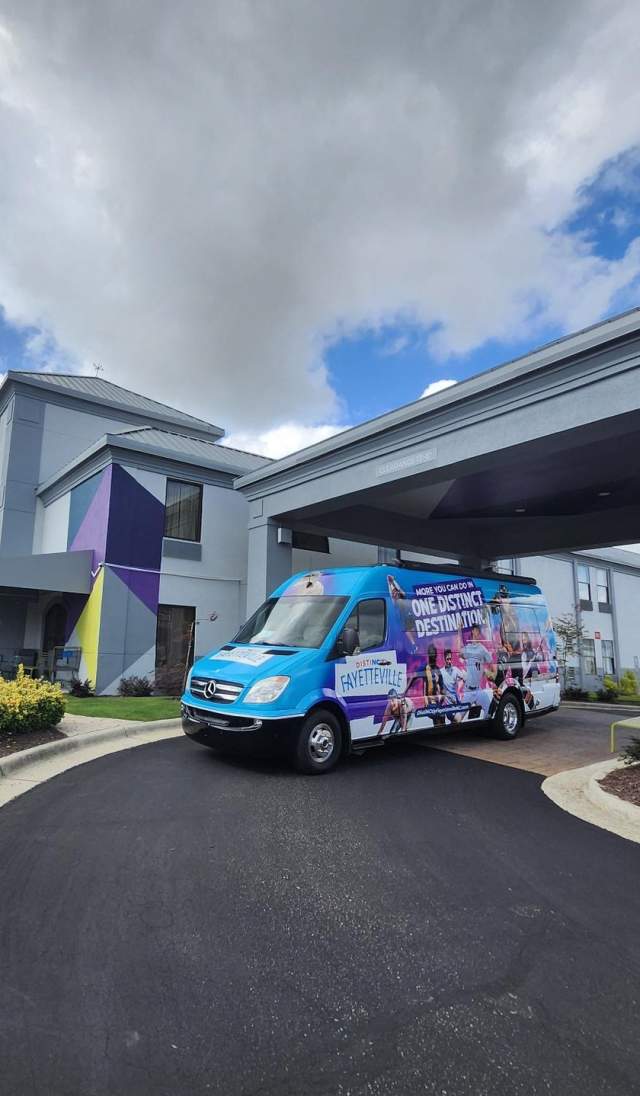 DistiNCtly Fayetteville MIC van parked at a local hotel, symbolizing community connection and volunteer engagement across Cumberland County.
