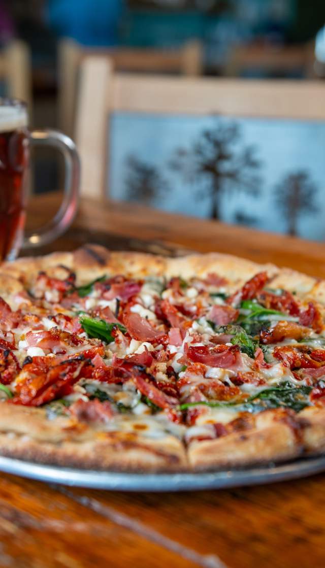 Pizza and a beer on a table