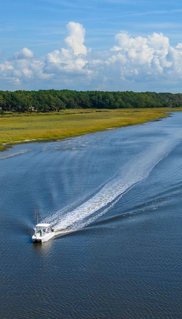 a boat traveling along the Intracoastal Waterway in Ocean Isle Beach