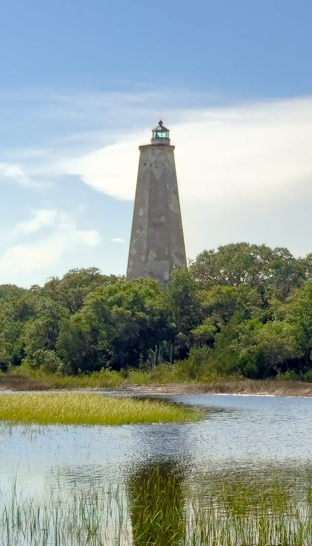 a view of Old Baldy Lighthouse on Bald Head Island over the marsh