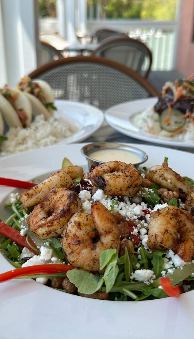 a salad with shrimp, boa bun tacos, and steak from Oak and Palm in Sunset Beach, NC