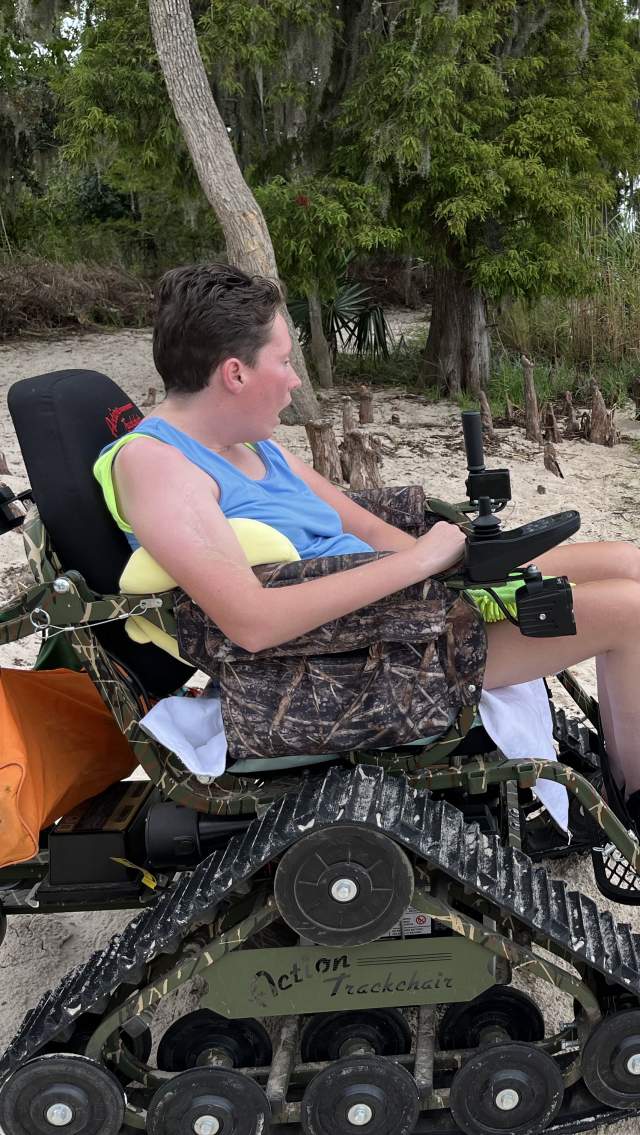The author's daughter is seated in Fontainebleau State Park's all-track wheelchair on the beach inside the park.
