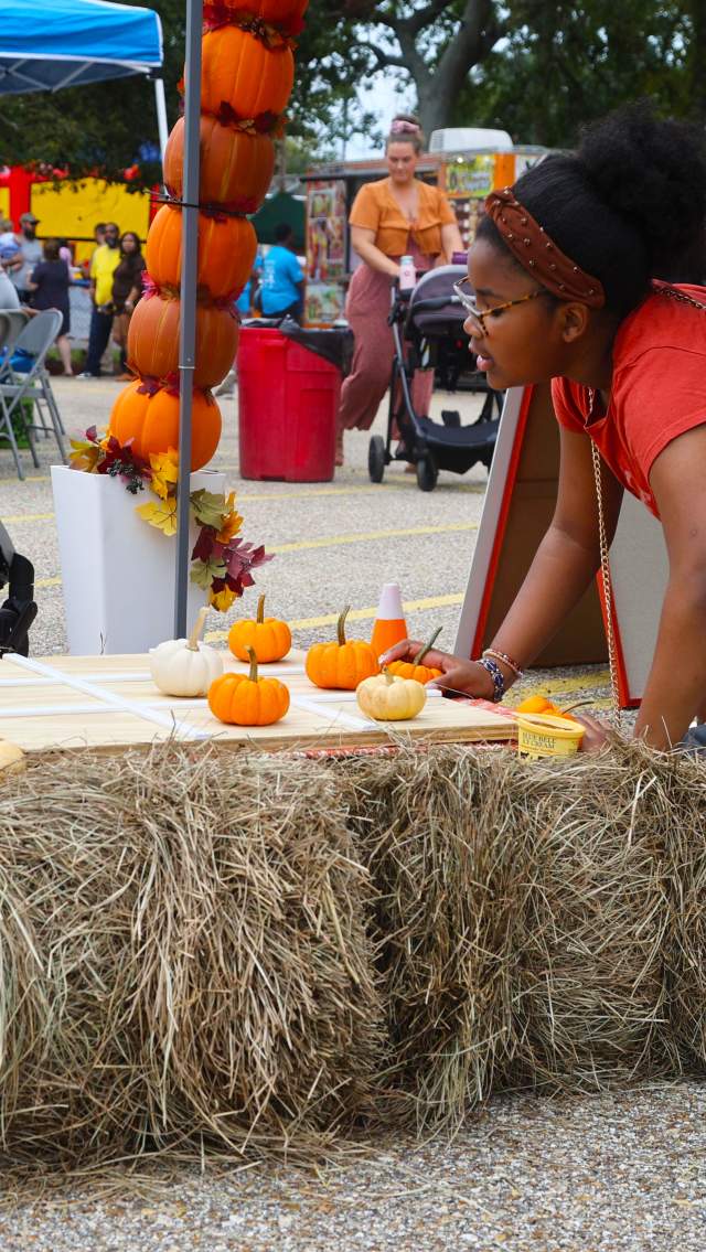 Children play with miniature pumpkins on hay bales during the Olde Towne Pumpkin Festival in Slidell.