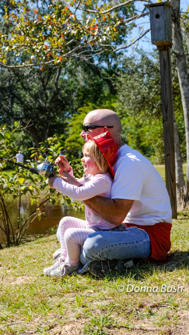 Man teaches little girl to fish at Wild Things at the Southeast Louisiana Wildlife Refuges Headquarters in Lacombe