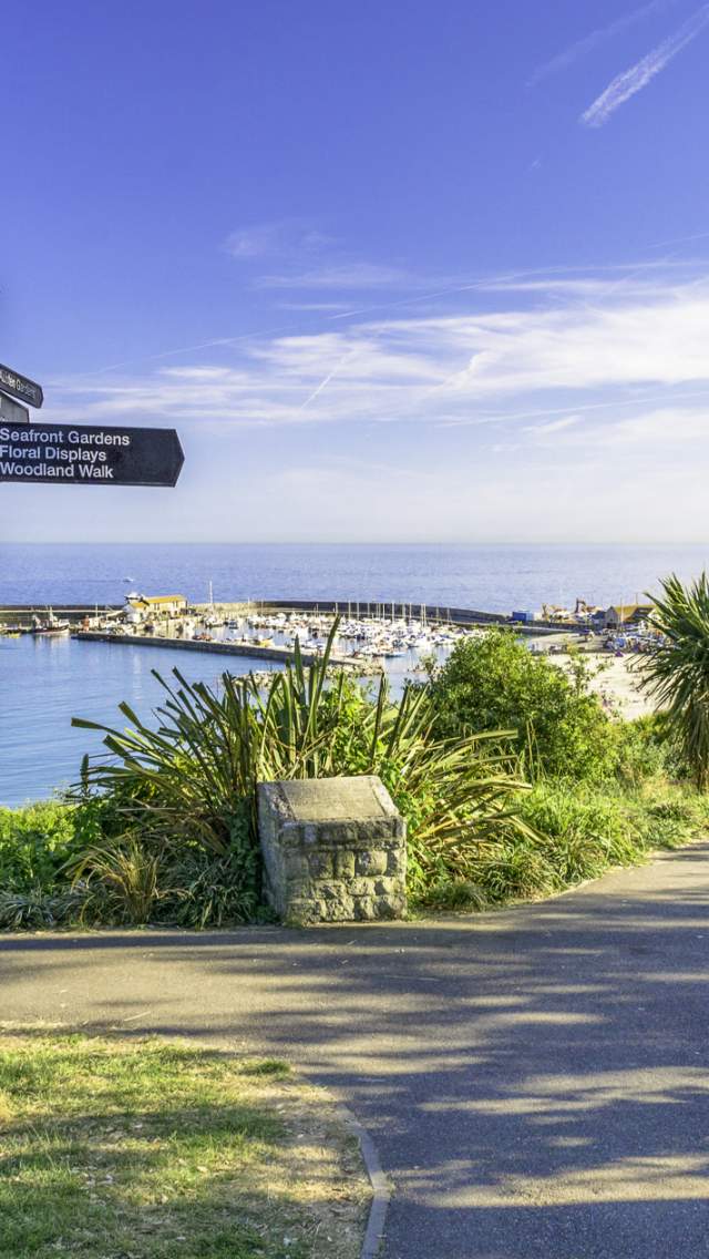 Sign post in Lyme Regis with sea views