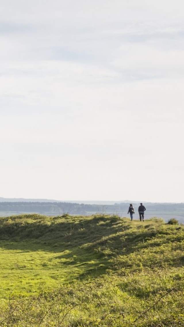 Two people walking at Badbury Rings.