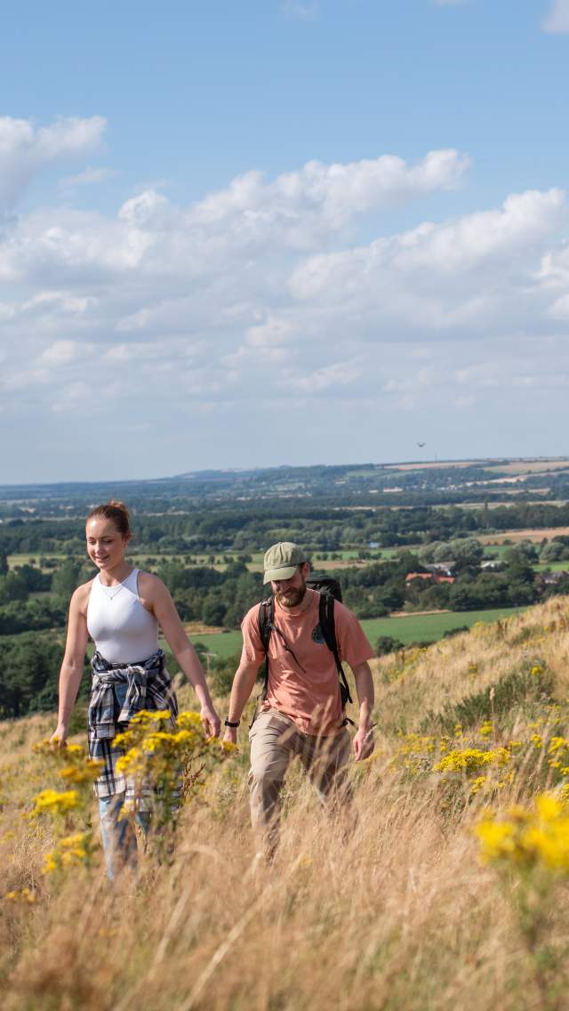 two people walking up a hillside in the Lincolnshire Wolds