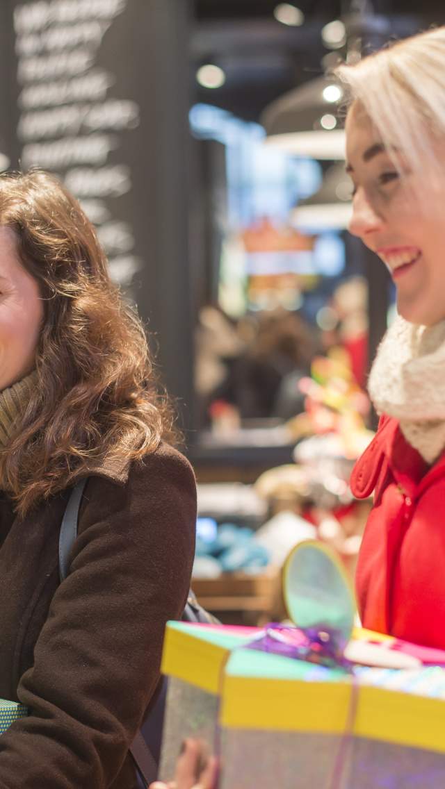 Two women shopping for Christmas presents in Bournemouth, Dorset