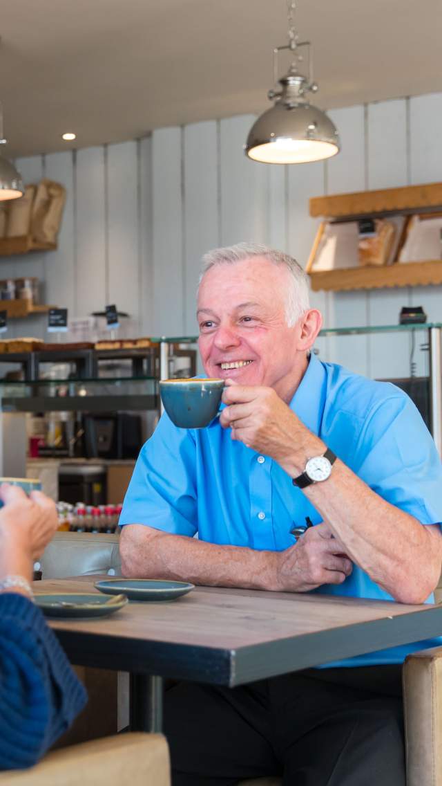 Two people enjoying a drink at a cafe in Swanage Dorset
