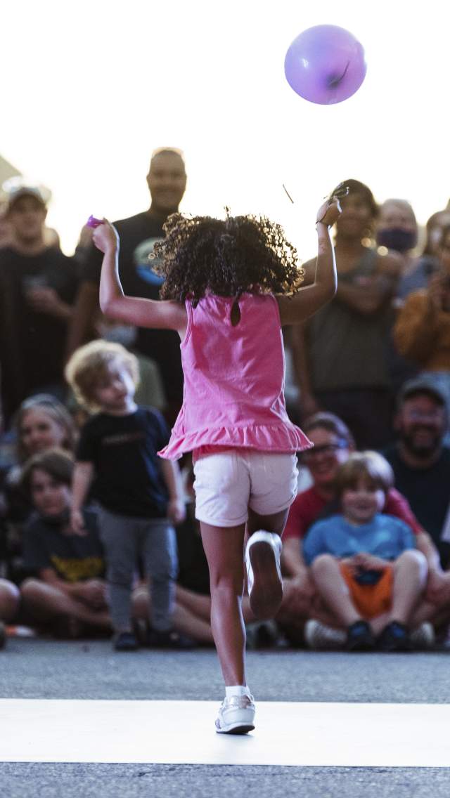 Girl dancing in Downtown Lawrence Kansas at the Busker Festival