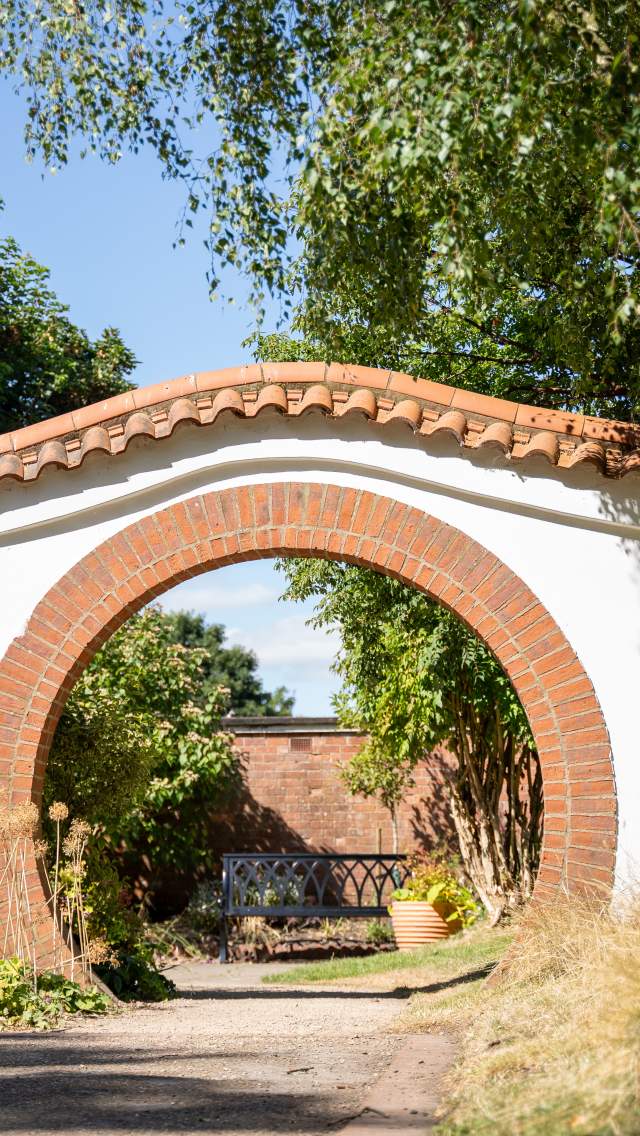 A stone arch in John Dawber Gardens, a community garden in the grounds of The Lawn in Lincoln