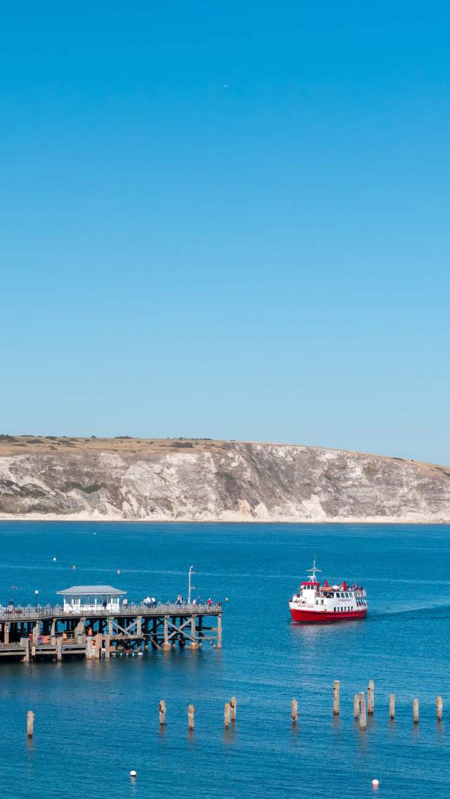 Swanage Pier in Dorset with a City Cruises boat arriving from Poole.