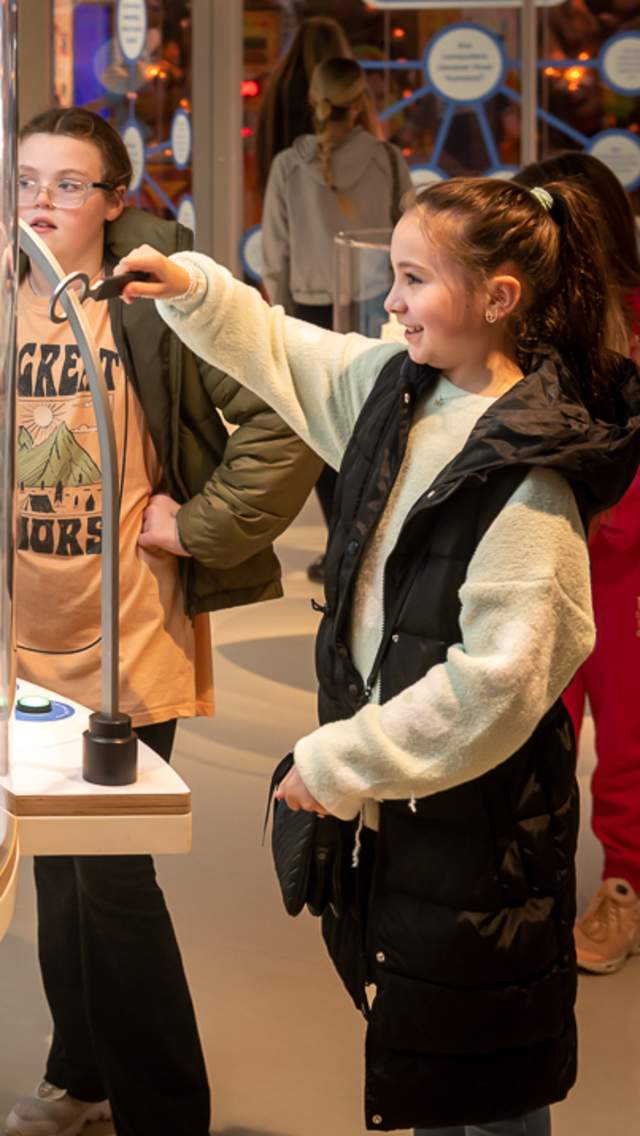 Girl interacting with robot exhibit at Eureka! Science + Discovery