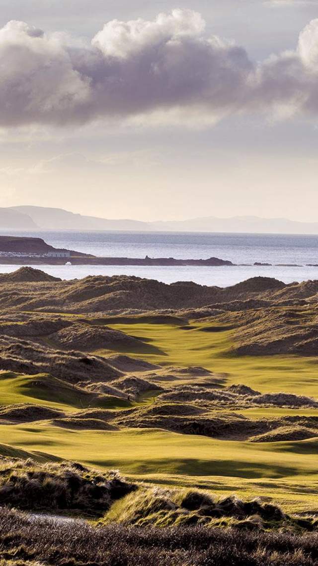 Aerial of the greens and fairways at Royal Portrush Golf Course overlooking the sea