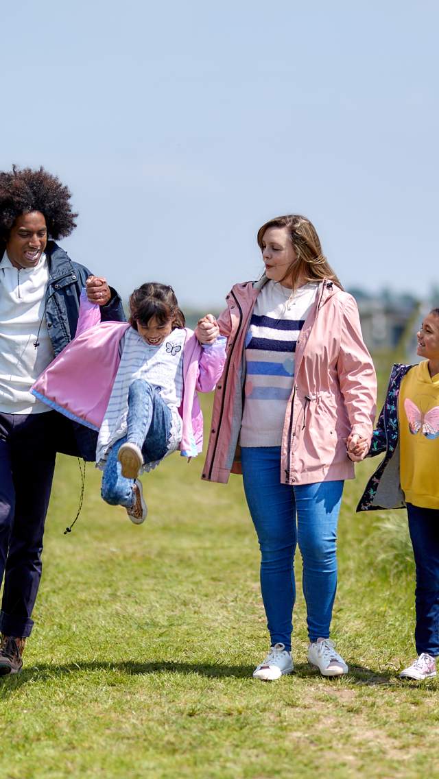 A family of four taking a walk at Parkdean Resorts Warmwell Holiday Park