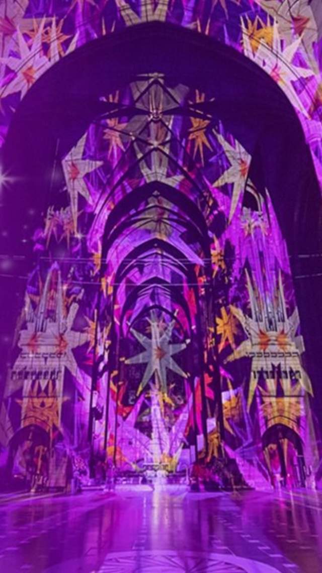 A purple image of a projection inside Liverpool Cathedral