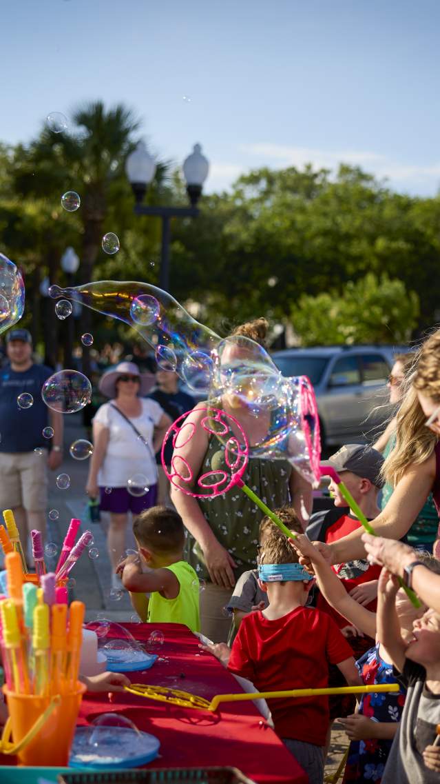 Blowing bubbles at First Friday in Downtown Brunswick