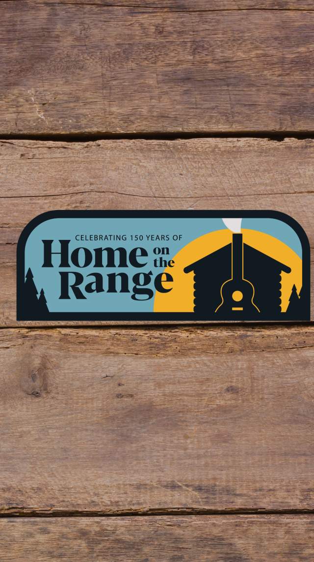 Blue and gold home range patch with a silhouette of a cabin in front of a sunset