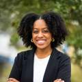 jazmyn's headshot in black blazer and white shirt