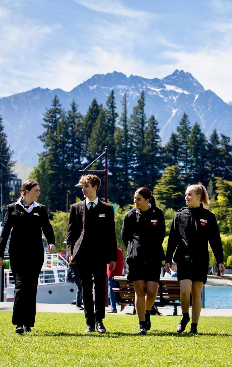 Group of students walking with mountains and lake view in background