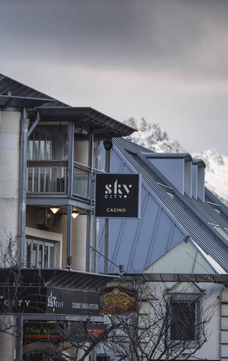 Outside view of Sky City Casino with snowy mountains in the background