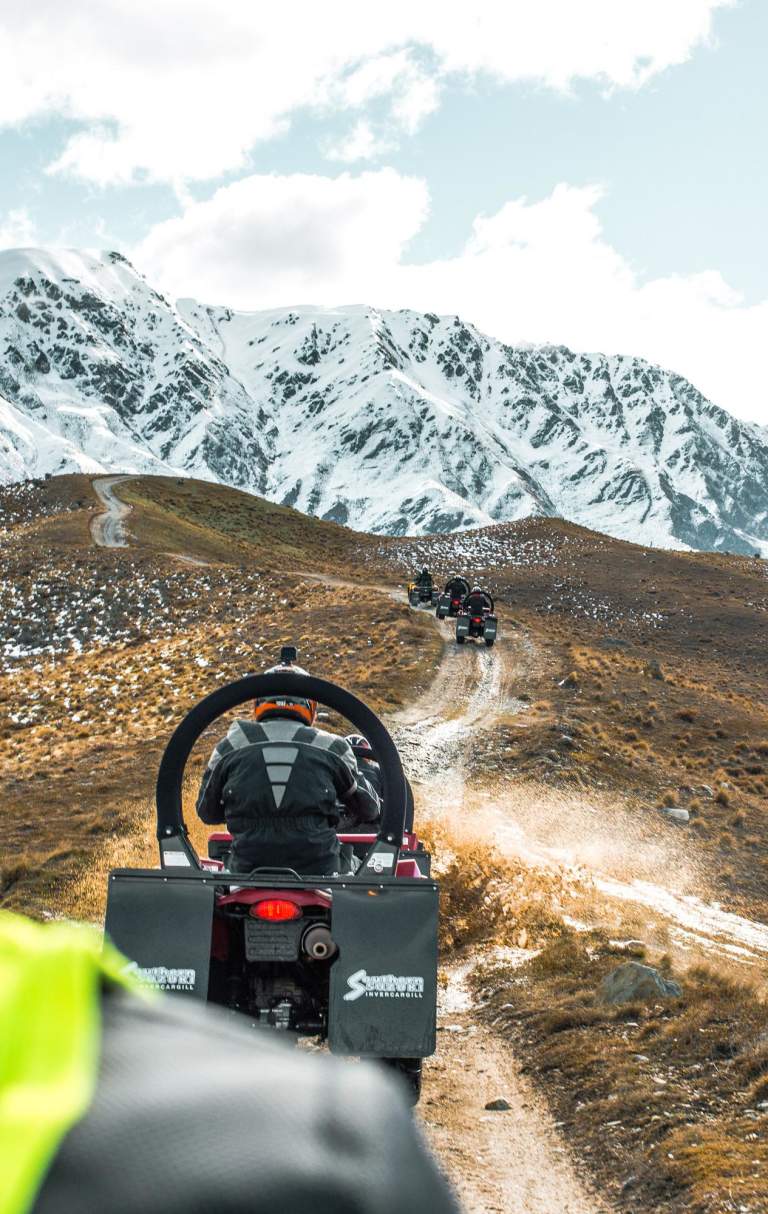 Quad biking on a dirt track at the top of a mountain