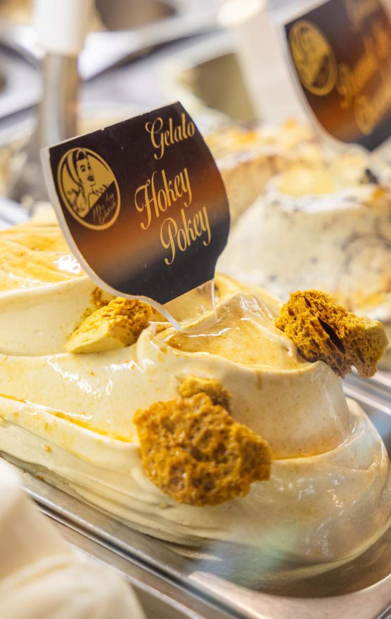Close up of gelato in a shop with a sign reading Hokey Pokey